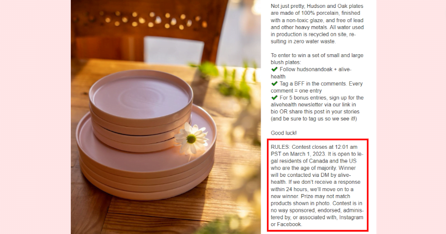 Pink plates stacked on a table with a flower on top