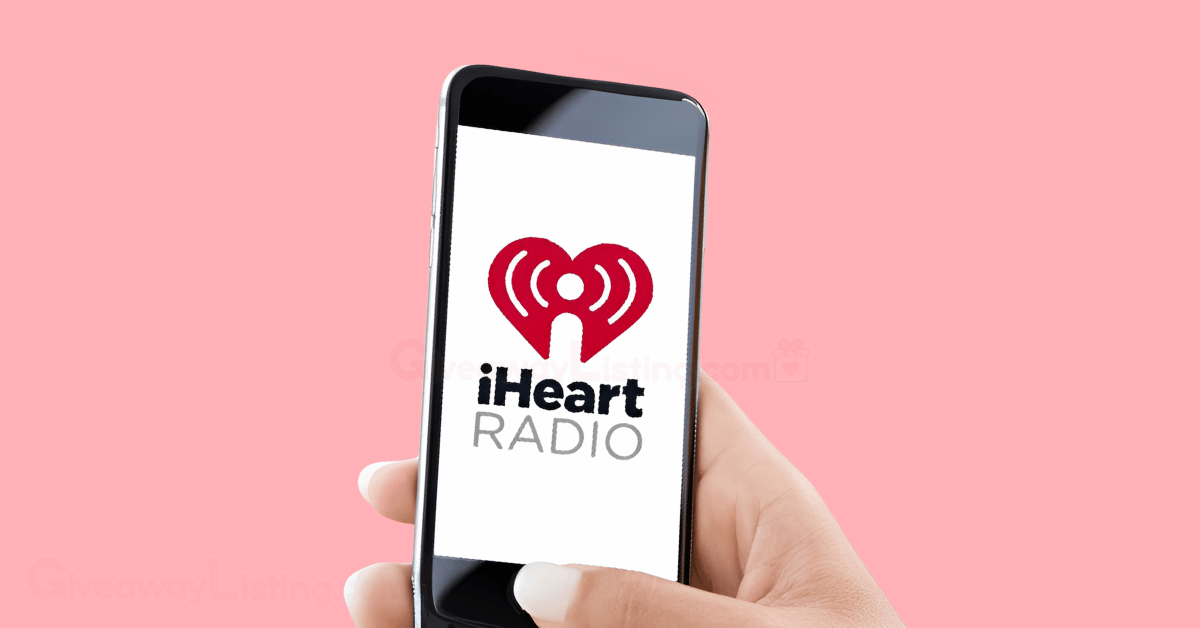 a hand holding a mobile phone with the iHeart Radio logo diplayed on the screen.