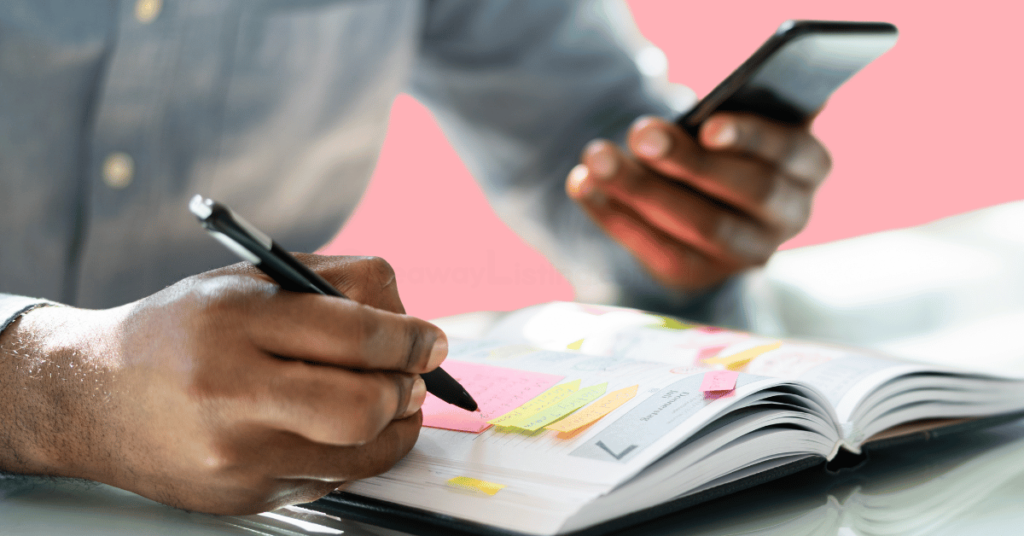 a person strategizing in a book with phone in hand on how to succeed in daily combos games