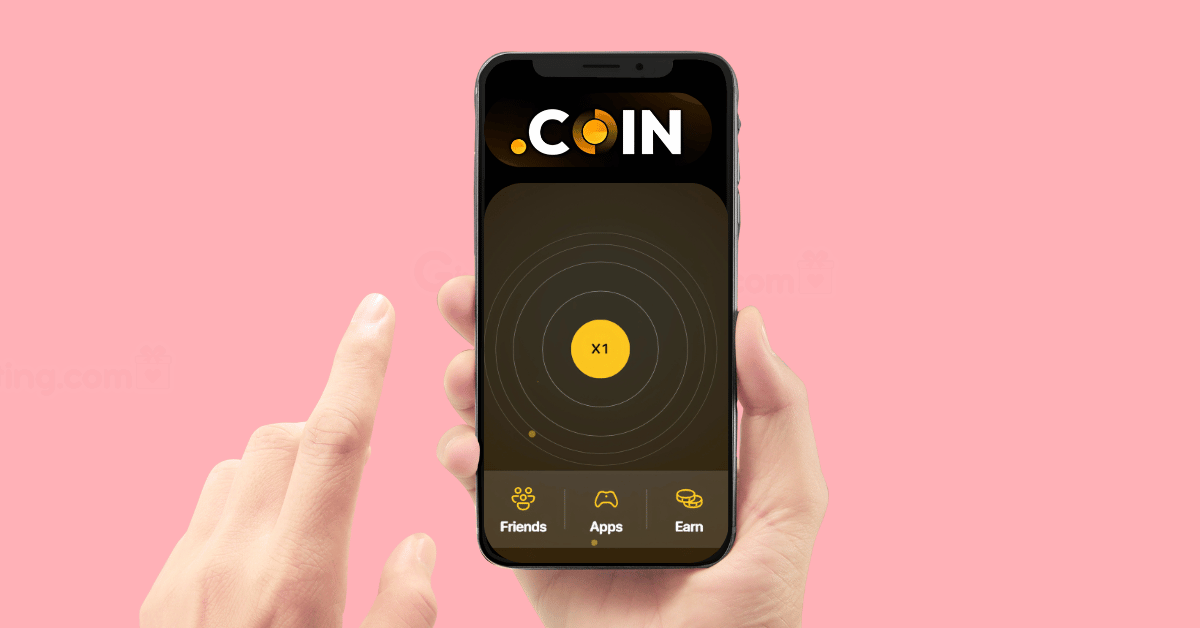 a hand holding a smartphone with the screen of the phone showing the Dotcoin logo and the tapping point on the game's app.