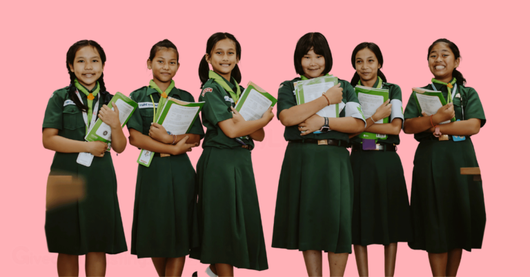a group of school girls in school uniforms, each holding a book.