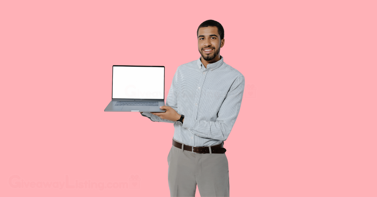 a man happily holding a laptop