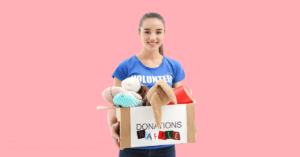 a volunteer holding a box marked as 'donations raffle' and filled with donated items.