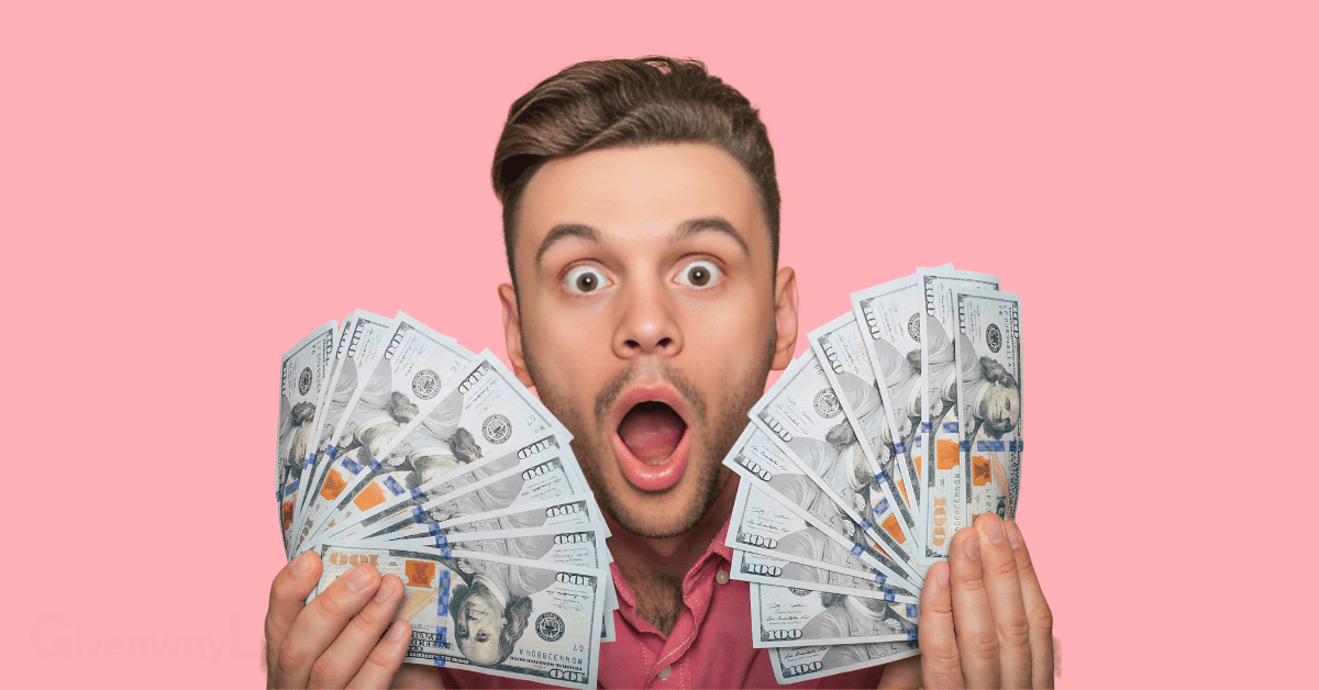a person holding a fan of dollar notes with his mouth open in shock.