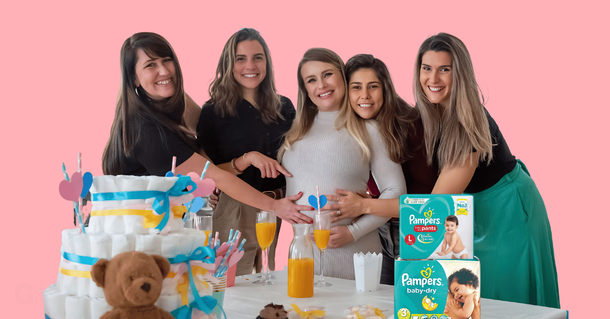 a pregnant woman surrounded by her friends during a baby shower with two packs of pampers diapers on the table in front of them.