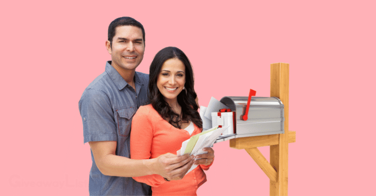 a couple holding freebie packages with their mailbox behind them.
