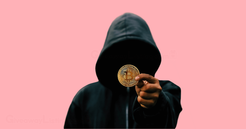 a faceless person wearing a hoodie and holding a bitcoin.